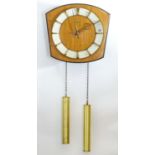 A retro Kieninger teak wall clock with two weights. 12" wide Please Note - we do not make