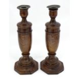 A pair of turned oak candlesticks. Approx. 12" high Please Note - we do not make reference to the