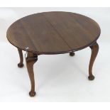 A mahogany oval wind out dining table with leaf. Please Note - we do not make reference to the