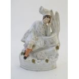 A Staffordshire pottery flat back figure depicting a Scottish soldier resting on a drum with a