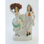 A Staffordshire pottery flat back figural group depicting a harvest couple, the man carries a flagon
