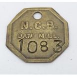 A brass National Coal Board token marked NCB Daw Mill, numbered 1083 Please Note - we do not make