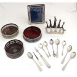 Assorted silver plated items to include coasters, spoons, picture frame and toast rack, etc.