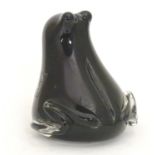 A late 20thC art glass figural ornament formed as a frog, black and clear glass, with label for