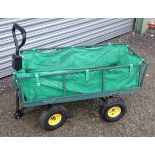 A garden barrow with four wheels, steering handle and collapsible sides. Approx. 41 1/2" long Please