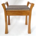 An oak piano stool with upholstered seat Please Note - we do not make reference to the condition