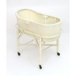 An early / mid 20thC Lloyd Loom childs crib, the basket having pierced handles and resting on a base