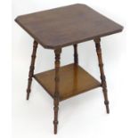 A late 19thC Aesthetic movement table with a moulded canted table top above four ring turned legs