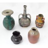 Five assorted vases to include a stoneware twin handled bottle base with incised banded detail, a