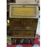 A 1930s oak bureau with turned legs Please Note - we do not make reference to the condition of