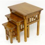 A nest of three mahogany occasional tables. The larges approx. 24" high Please Note - we do not make