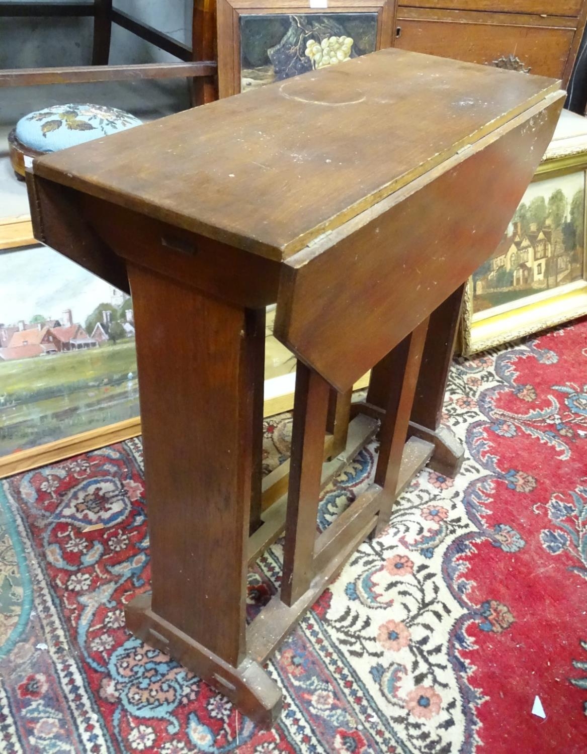 A Cotswold school style oak drop flap table with a chamfered frame and exposed construction. 30"