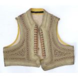 A small braided waistcoat Please Note - we do not make reference to the condition of lots within