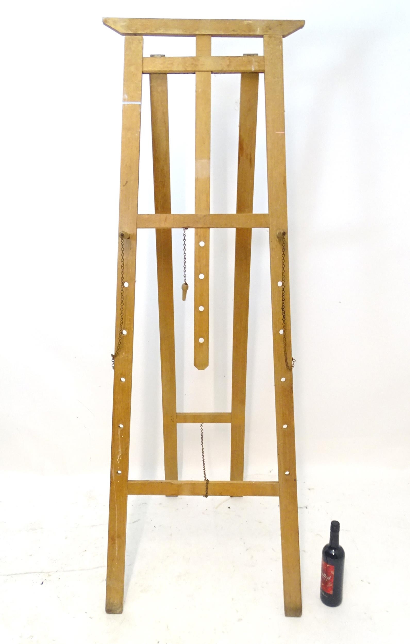 A 20thC artist's easel. Approx. 73 3/4" high Please Note - we do not make reference to the condition