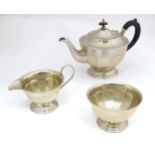 An Art Deco silver plated three piece tea service Please Note - we do not make reference to the