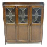 A 1930s oak bookcase with three tiers and three glazed doors. Approx. 39 1/4" wide Please Note -