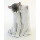 A Continental model of two seated cats. Marked under 9066. Approx. 7 3/4" high Please Note - we do