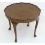An early / mid 20thC pie crust walnut occasional table standing on four cabriole legs. 24" in