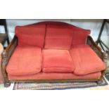 A carved bergere three seater sofa with lion paw feet Please Note - we do not make reference to