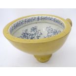 A stoneware toilet bowl with blue and white floral decoration Please Note - we do not make reference