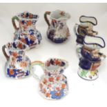 Four ironstone jugs with floral and foliate detail, together with two Allertons Toby jugs (6) Please