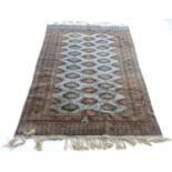 A 20thC rug / carpet with a pale blue ground and decorative border. Approx 70" long Please Note - we