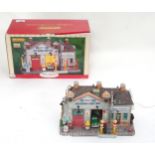 A boxed Lemax lighted building model auto repair and body shop, from The Village Collection