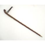 A mid 20thC Alpine hiking stick, the chestnut shank with leather strap and spike ferrule,