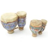 Two pairs of bongo drums with decorated ceramic bodies. Please Note - we do not make reference to