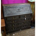 A 19thC carved oak bureau Please Note - we do not make reference to the condition of lots within