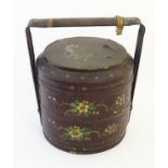 A Chinese lacquered food storage container / carrier of cylindrical form with two tiers and a bamboo