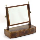 A 19thC mahogany toilet mirror surmounted by brass finials above a satinwood strung frame and