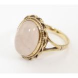 A 9ct gold ring set with rose quartz oval cabochon to top. Ring size approx. N ( matching to lot