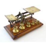 Late 19th / early 20thC brass postal balance scales with seven weights. Approx. 3 3/4" high x 8 1/2"