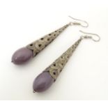 A pair of drop earrings, the mauve beads mounted in Art deco style white metal mounts. Approx 3"