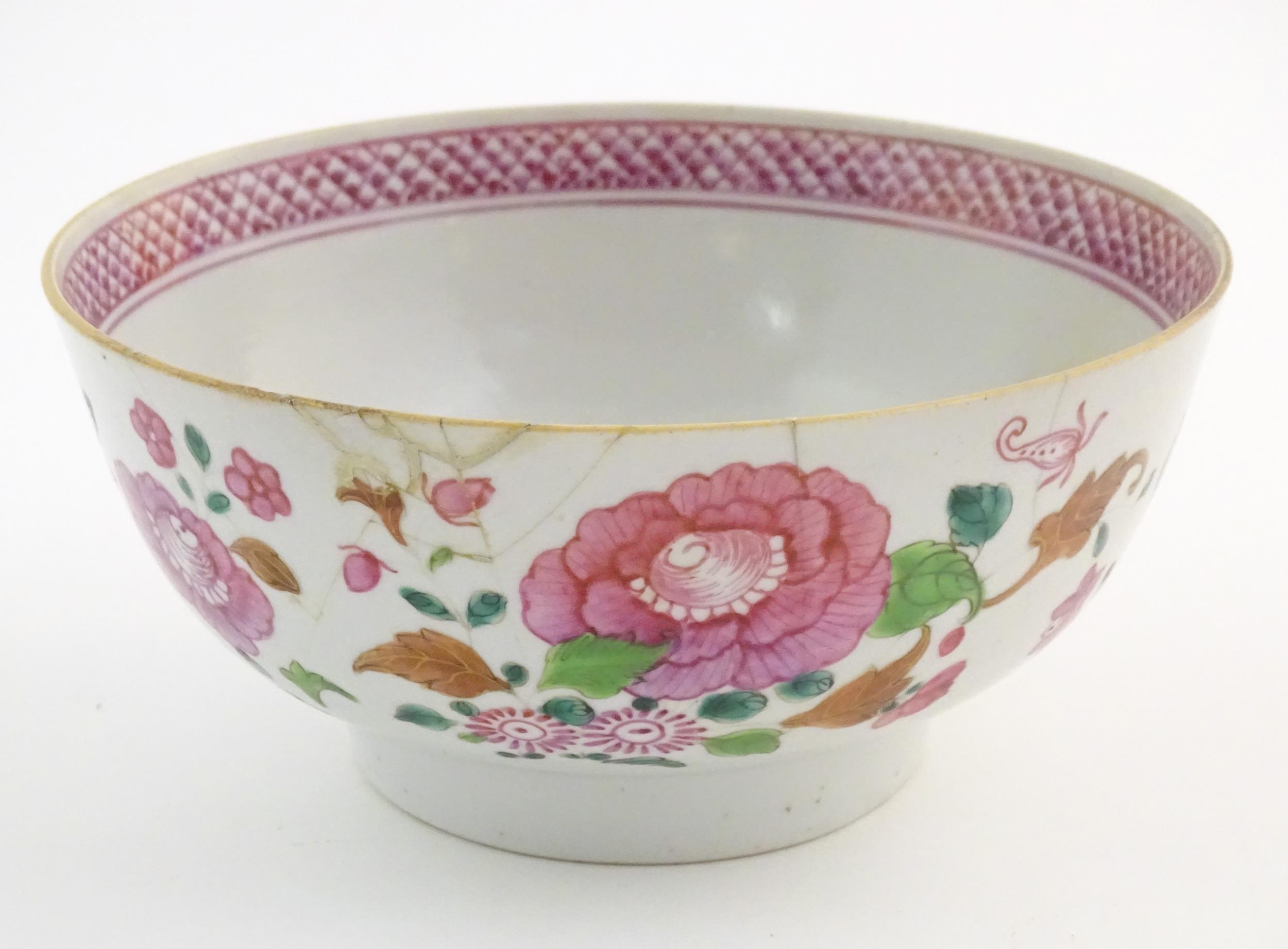 A Chinese bowl decorated with flowers and foliage, with floral motif to centre of interior and