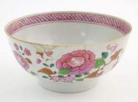 A Chinese bowl decorated with flowers and foliage, with floral motif to centre of interior and