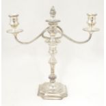 A silver plate table candelabra with two scrolling branches. Approx 13" high Please Note - we do not