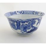 A Chinese blue and white footed bowl with a flared rim, decorated with a scene depicting the