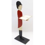 A 20thC painted dumb waiter modelled as a gentleman in hunting pinks. Approx. 41 1/2" high Please
