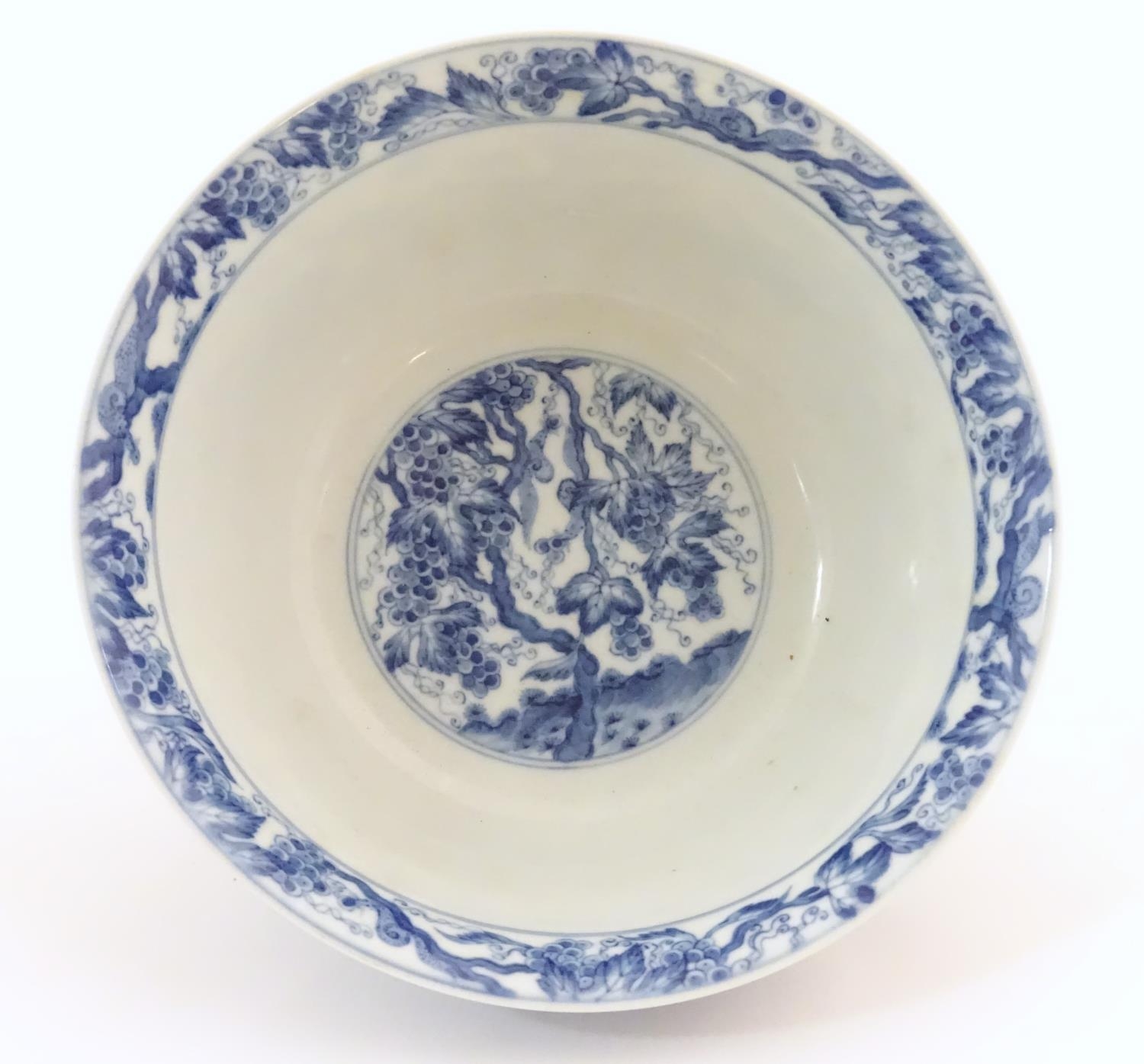 A Chinese blue and white bowl decorated with vine leaves and grapes. Character marks under. - Image 6 of 9