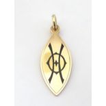 A Victorian mourning pendant of elliptical form with enamel decoration and engraved and dated to