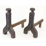 A pair of 19thC cast iron fire dogs / andirons with foliate and cartouche detail. Approx. 16 1/4"