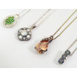 4 assorted silver necklaces ( pendants and chains ) to include a silver gilt example. (4) Please