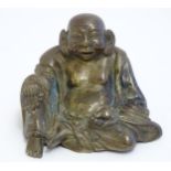 A Chinese cast model of Budai - The Laughing Buddha. Approx. 3 3/4" high Please Note - we do not