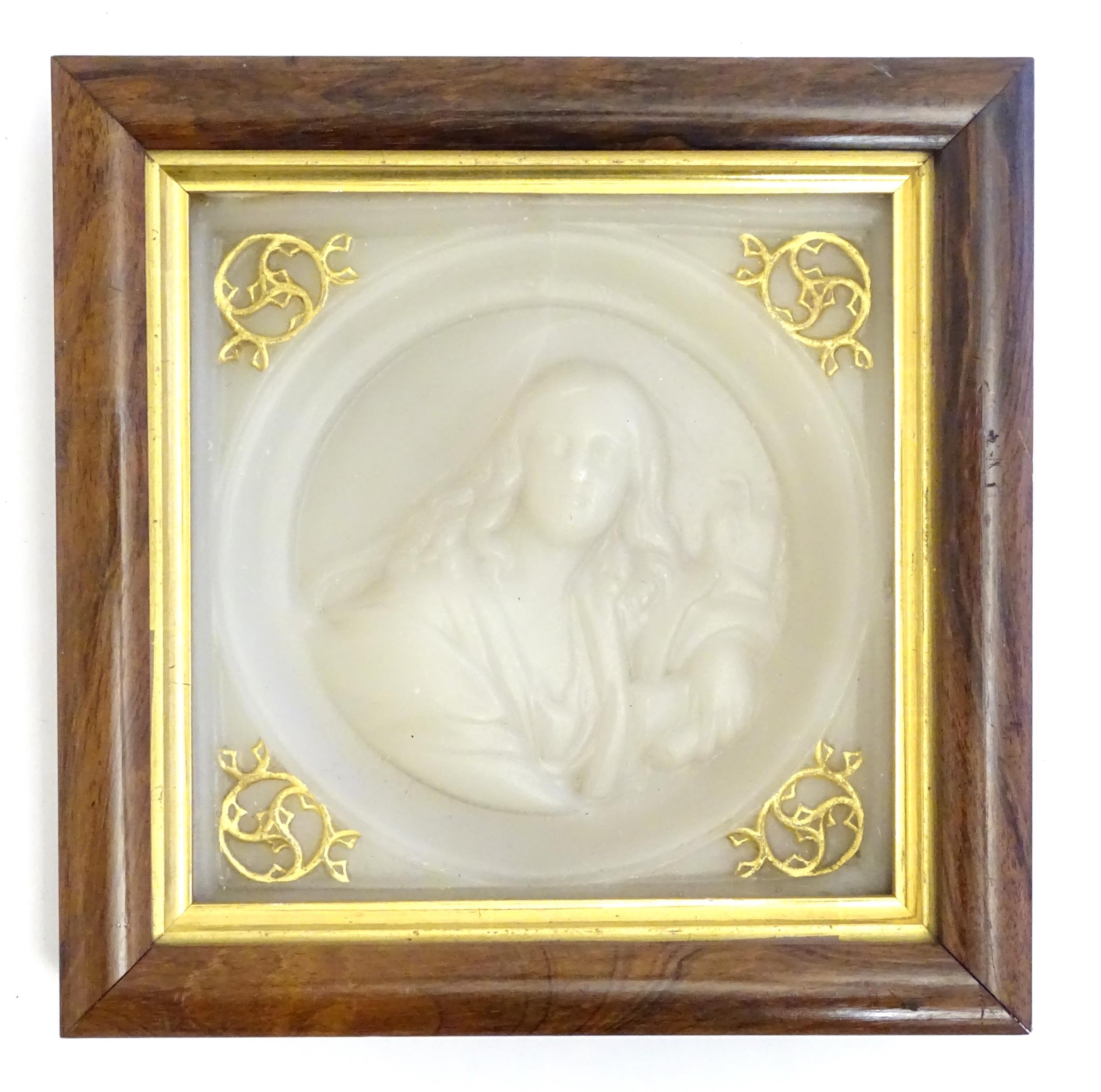 A 19thC wax tondo portrait depicting a woman holding a scroll. Ascribed and titled verso Womanhood