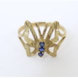 A 9ct gold ring with butterfly decoration to top set with blue stones. Ring size approx. L Please