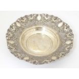 A silver plate dish with embossed cherub detail. 11" diameter Please Note - we do not make reference