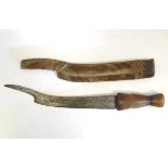 Ethnographic / Native / Tribal: An African knife with curved blade and hooked end, wooden handle,