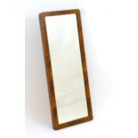 An early / mid 20thC rectangular mahogany mirror with a figured surround. 45" high x 18" wide.